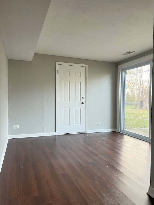 unfurnished bedroom with dark wood-type flooring