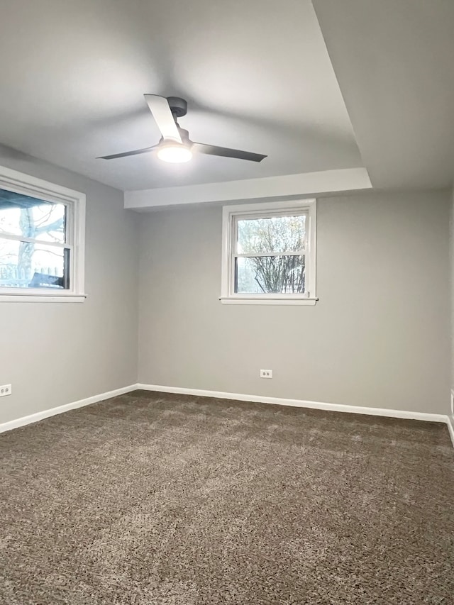 carpeted empty room featuring ceiling fan