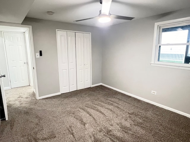 unfurnished bedroom with carpet, a closet, and ceiling fan