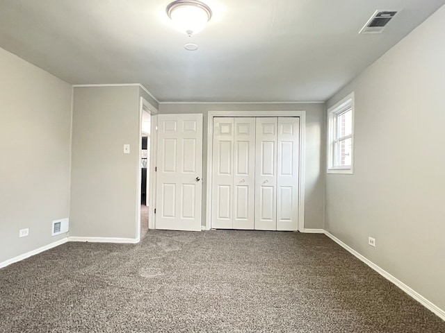 unfurnished bedroom with a closet and carpet floors