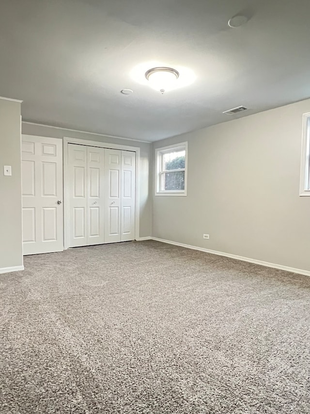 unfurnished bedroom featuring carpet and a closet