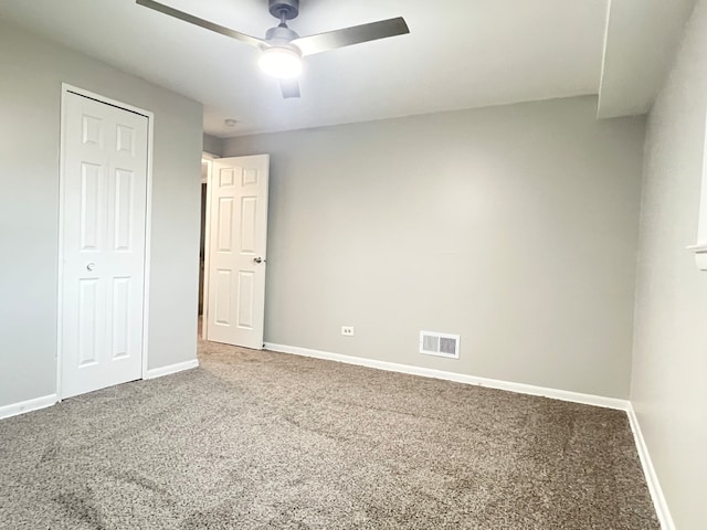 empty room with carpet flooring and ceiling fan