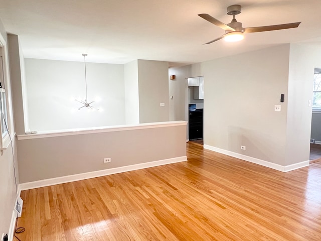 empty room with hardwood / wood-style floors and ceiling fan