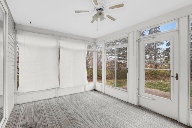 unfurnished sunroom with ceiling fan