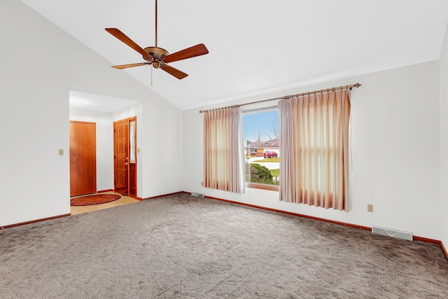 carpeted empty room featuring ceiling fan and high vaulted ceiling