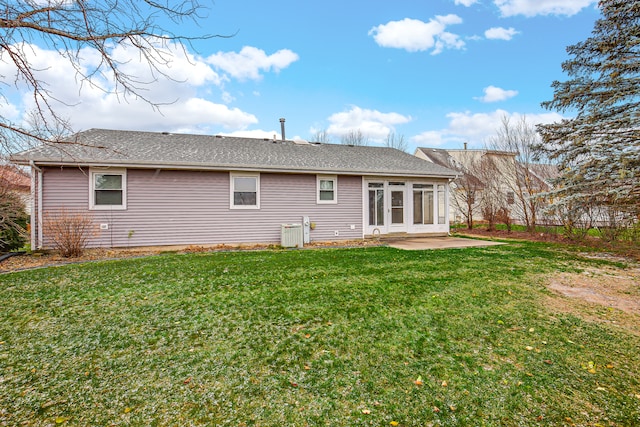 rear view of property with a patio and a lawn