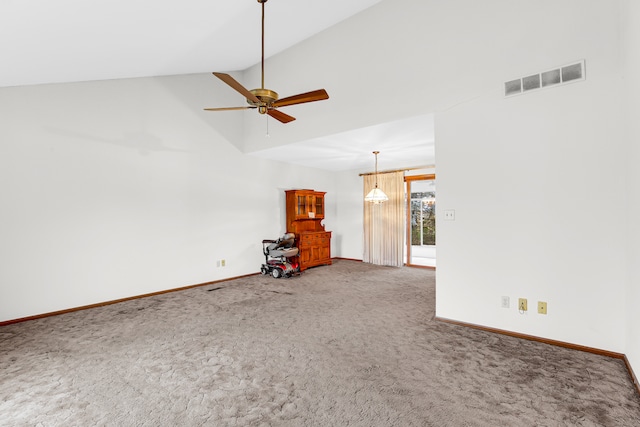 unfurnished living room with carpet, high vaulted ceiling, and ceiling fan