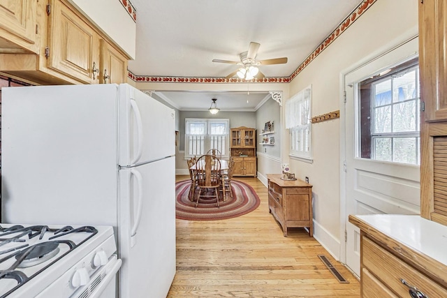 kitchen with light hardwood / wood-style flooring, ceiling fan, ornamental molding, light brown cabinetry, and white range oven