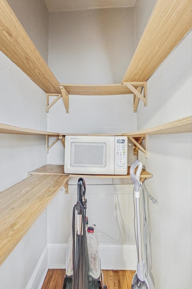 laundry room with hardwood / wood-style flooring