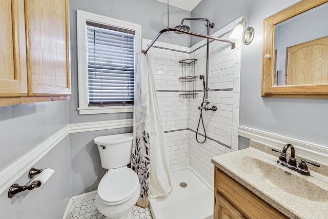 bathroom featuring tile patterned floors, vanity, toilet, and walk in shower