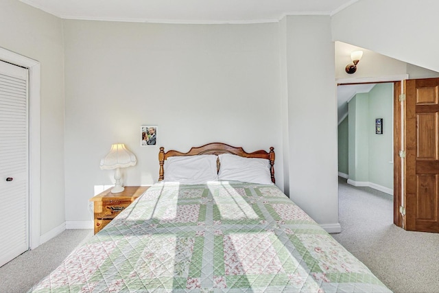 bedroom featuring carpet, crown molding, and a closet