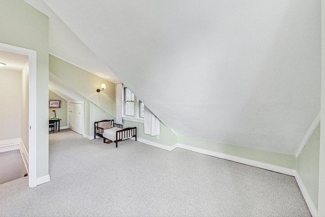 interior space with light colored carpet and lofted ceiling