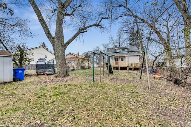 view of yard with a deck and a trampoline