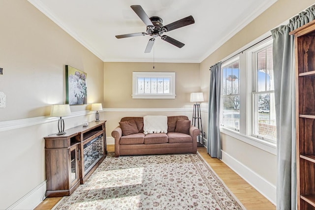 living room featuring ceiling fan, light hardwood / wood-style flooring, and ornamental molding