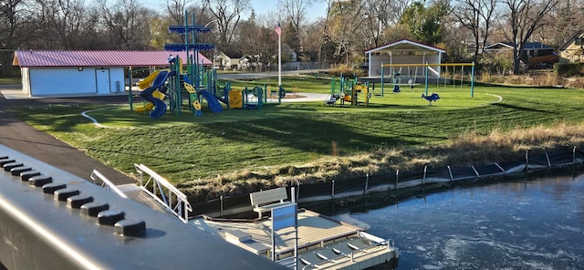 view of property's community with a playground and a lawn