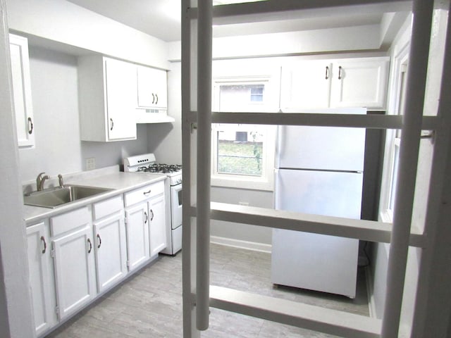 laundry area with light wood-type flooring and sink