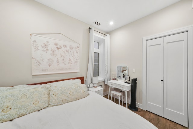 bedroom featuring dark hardwood / wood-style floors and a closet