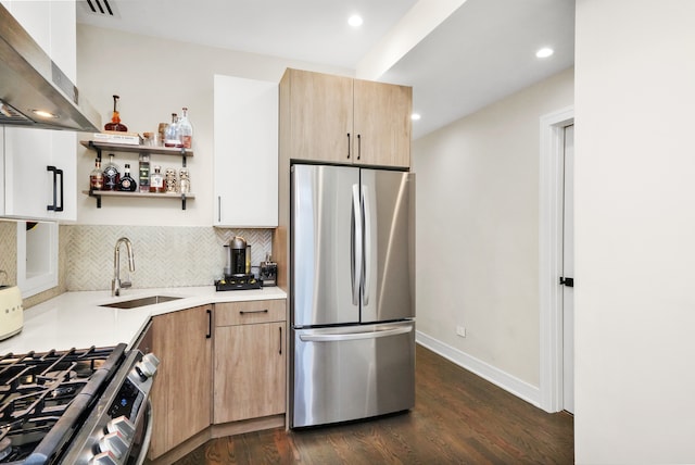 kitchen with sink, wall chimney exhaust hood, stainless steel fridge, decorative backsplash, and dark hardwood / wood-style flooring