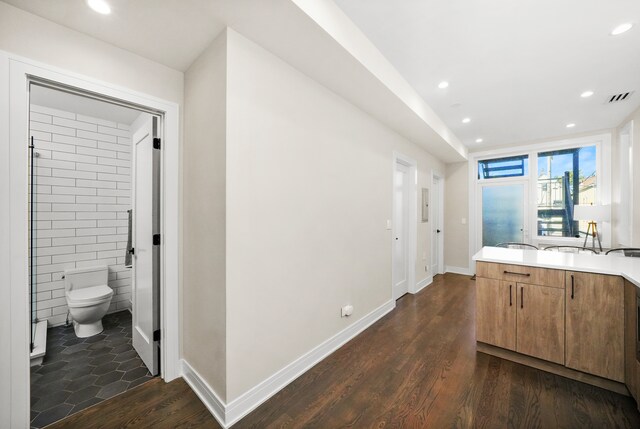 kitchen featuring dark hardwood / wood-style flooring and tile walls