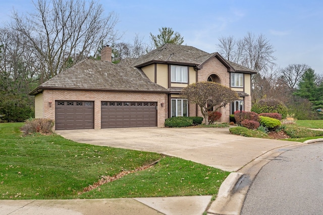 view of front of home with a front lawn and a garage