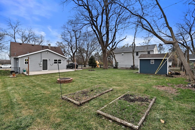 view of yard with a patio, an outdoor fire pit, and a storage shed