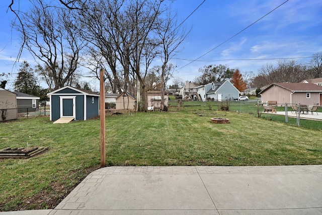 view of yard with a patio, a fire pit, and a storage shed