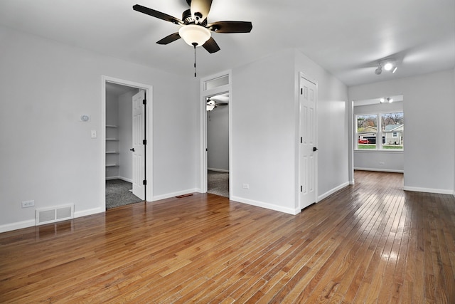 empty room featuring wood-type flooring and ceiling fan