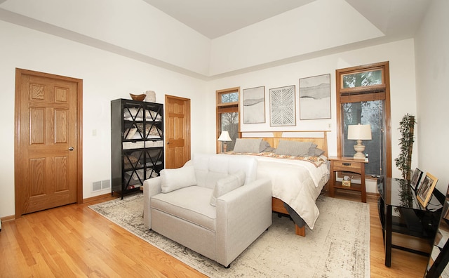 bedroom featuring light wood-type flooring and multiple windows