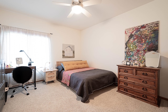 bedroom with ceiling fan and light carpet