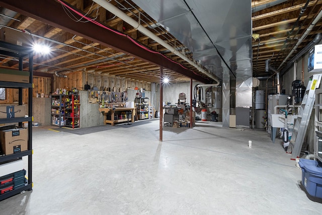 basement featuring a workshop area and water heater