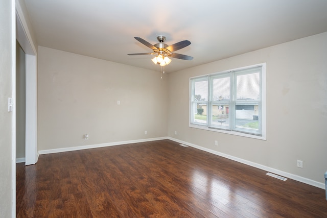 empty room featuring ceiling fan and dark hardwood / wood-style flooring