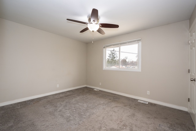 carpeted spare room featuring ceiling fan