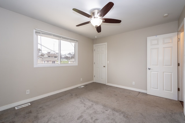 empty room featuring carpet flooring and ceiling fan