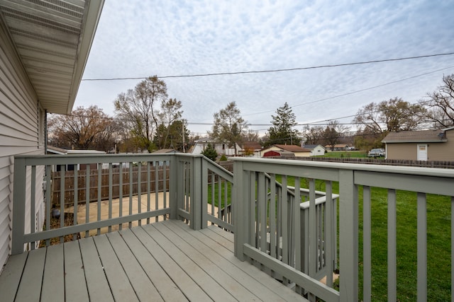 wooden deck featuring a yard