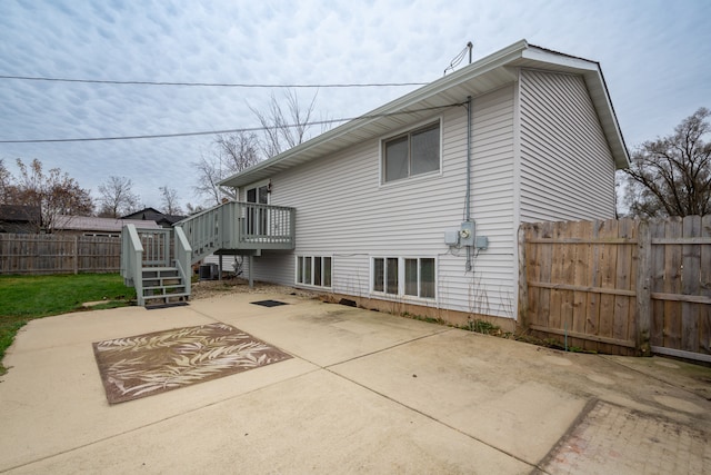 back of property featuring a patio area, a deck, and central AC