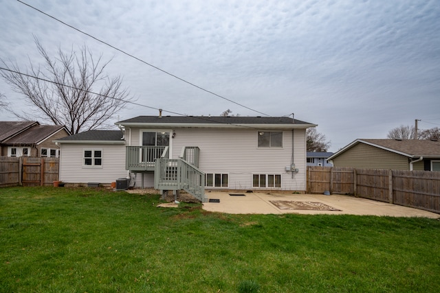 rear view of property featuring central air condition unit, a patio area, a yard, and a wooden deck