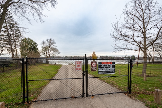 view of gate featuring a lawn