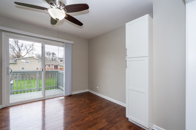 unfurnished room featuring dark hardwood / wood-style floors and ceiling fan