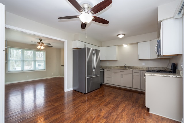 kitchen with dark hardwood / wood-style flooring, white cabinetry, sink, and appliances with stainless steel finishes