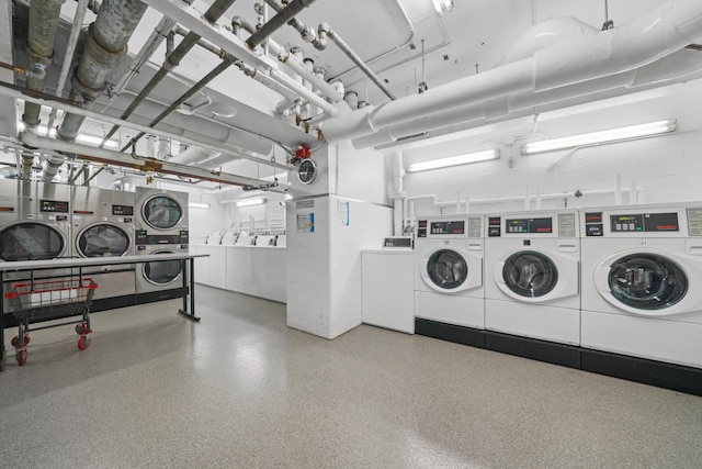 clothes washing area featuring washing machine and dryer and stacked washing maching and dryer