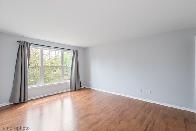 unfurnished room with light hardwood / wood-style floors