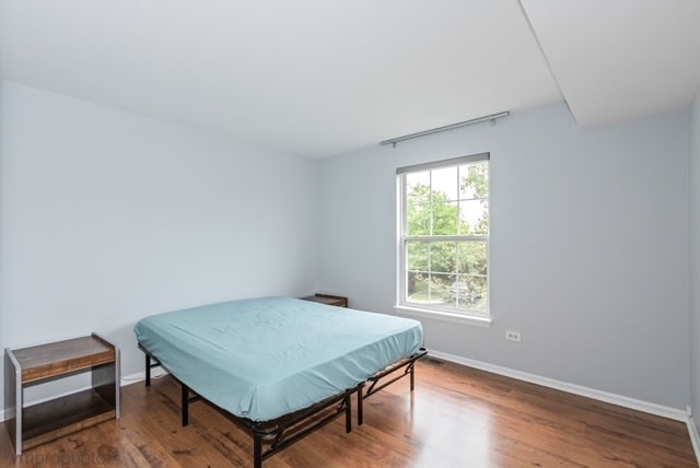 bedroom with hardwood / wood-style flooring and billiards