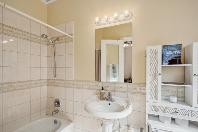 bathroom featuring ceiling fan, shower / bath combo with shower curtain, and sink