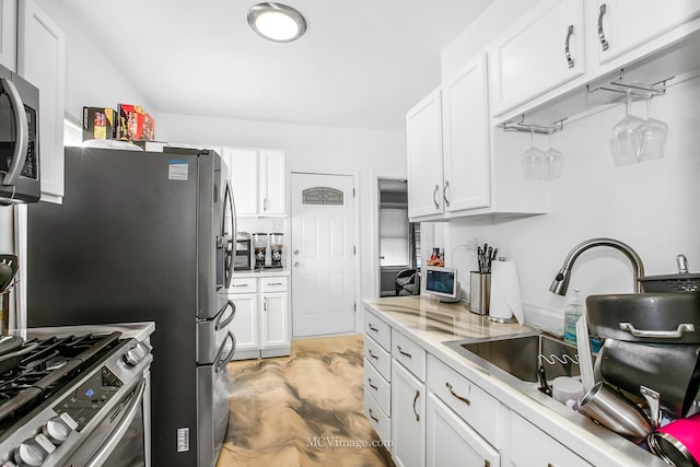 kitchen with white cabinetry, sink, and stainless steel appliances