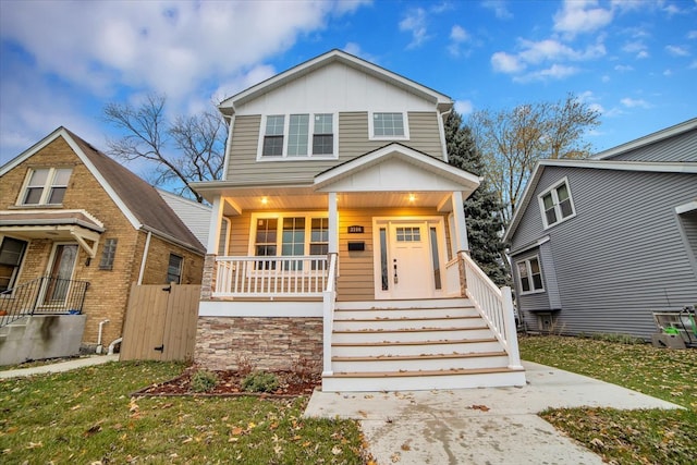 view of front of property with covered porch and a front yard