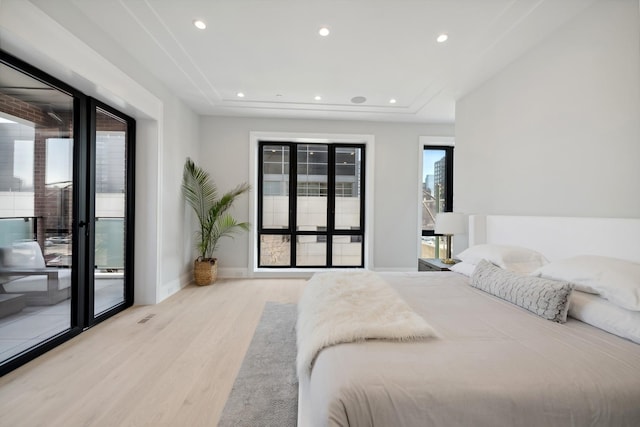 bedroom featuring light wood-type flooring and access to outside