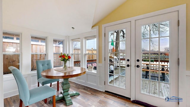 doorway to outside with lofted ceiling, wood-type flooring, and french doors