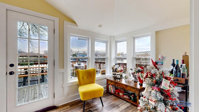 sunroom featuring vaulted ceiling and a healthy amount of sunlight