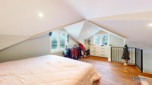 bedroom with wood-type flooring and lofted ceiling