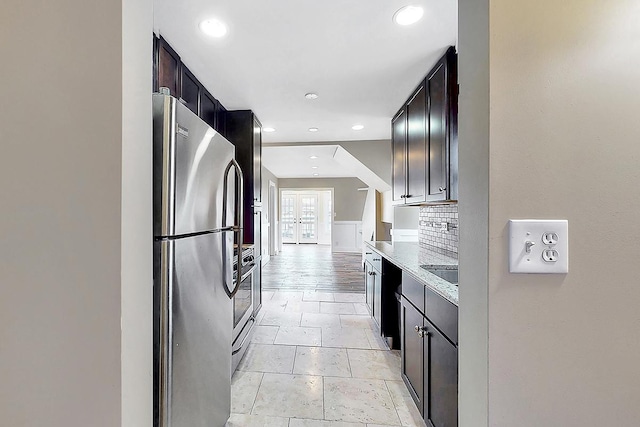 kitchen featuring recessed lighting, freestanding refrigerator, range, and decorative backsplash